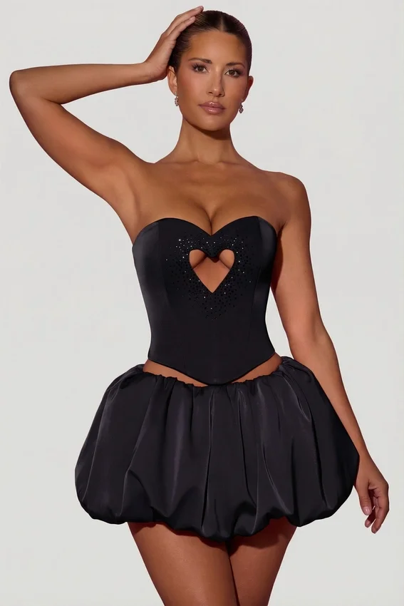 Amora Embellished Heart Cut-Out Strapless Corset Top i svart Amora Embellished Heart Cut-Out Strapless Corset Top i svart