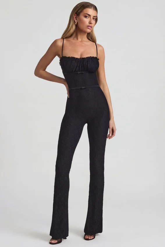 Arlena Jumpsuit med spets och rosettdetaljer i svart Arlena Jumpsuit med spets och rosettdetaljer i svart