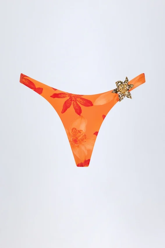 Beqa Bikinibyxor med metalldetaljer i orange orkidé-mönster Beqa Bikinibyxor med metalldetaljer i orange orkidé-mönster