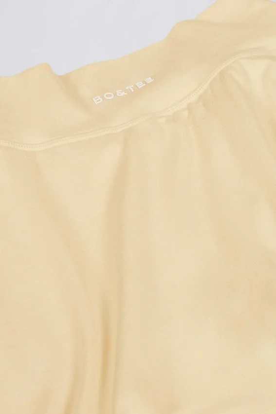 Borstad jersey-miniskort med korslagd midja i citrongul melerad Borstad jersey-miniskort med korslagd midja i citrongul melerad