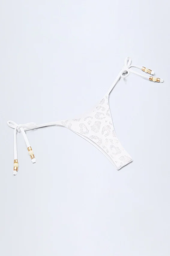 Cebu bikinibyxor med sidoknytning och pärlor i vit leopardmönster Cebu bikinibyxor med sidoknytning och pärlor i vit leopardmönster
