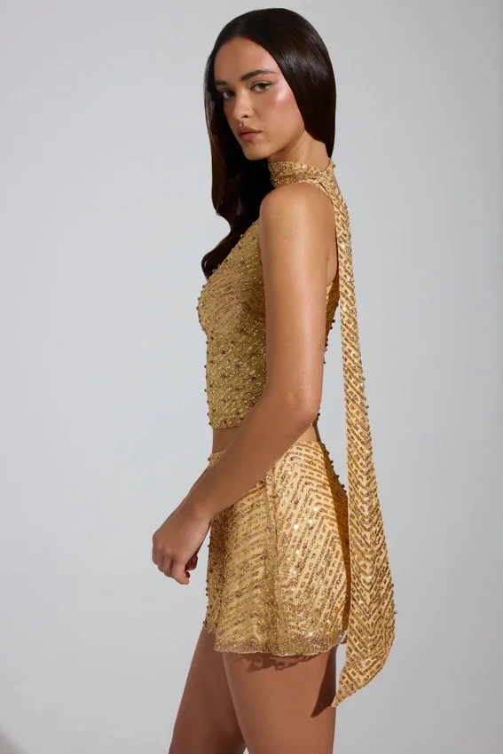 Cosette-top med asymmetrisk scarf-detalj i guld Cosette-top med asymmetrisk scarf-detalj i guld