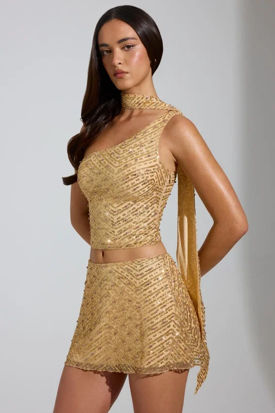 Cosette-top med asymmetrisk scarf-detalj i guld Cosette-top med asymmetrisk scarf-detalj i guld