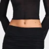 Diana genomskinlig jerseykjol med låg midja och draperingar i svart Diana genomskinlig jerseykjol med låg midja och draperingar i svart