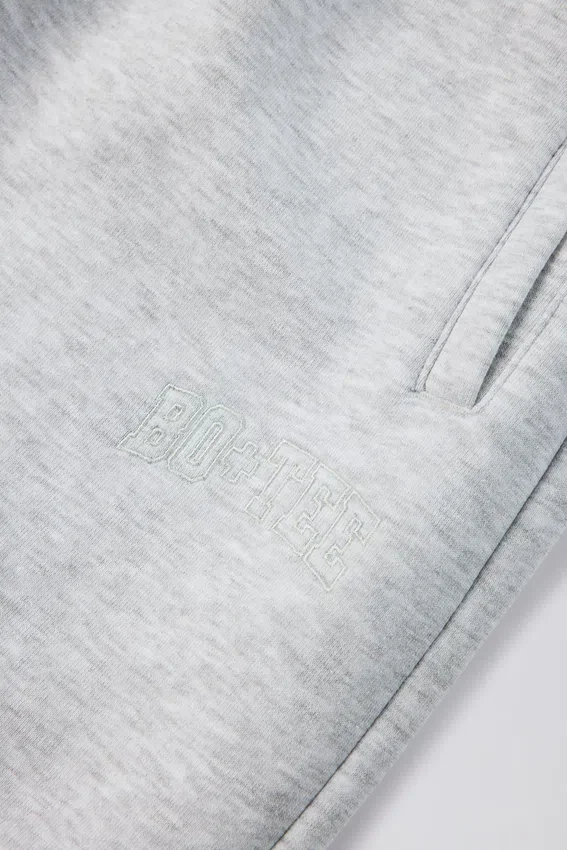Joggingbyxor i borstad bomullsjersey med medelhöjd midja och avslappnad passform i gråmelerat Joggingbyxor i borstad bomullsjersey med medelhöjd midja och avslappnad passform i gråmelerat