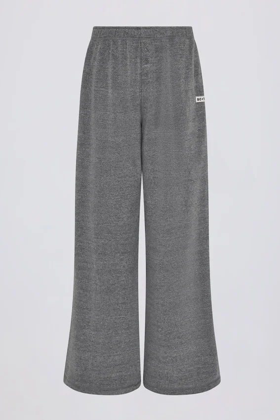 Joggingbyxor i mörkgrå texturerad bomull med knappar, låg midja och vida ben Joggingbyxor i mörkgrå texturerad bomull med knappar, låg midja och vida ben