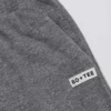 Joggingbyxor i mörkgrå texturerad bomull med knappar, låg midja och vida ben Joggingbyxor i mörkgrå texturerad bomull med knappar, låg midja och vida ben
