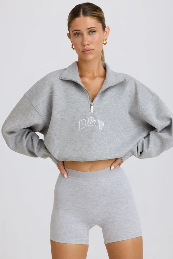 Kort sweatshirt med kvartslång dragkedja i gråmelerat Kort sweatshirt med kvartslång dragkedja i gråmelerat