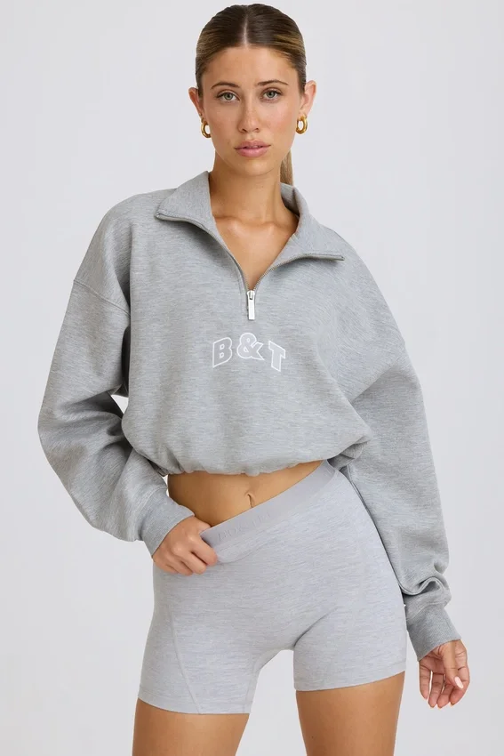 Kort sweatshirt med kvartslång dragkedja i gråmelerat Kort sweatshirt med kvartslång dragkedja i gråmelerat