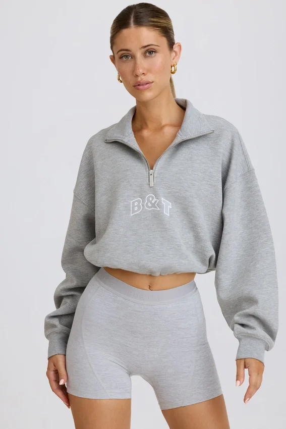 Kort sweatshirt med kvartslång dragkedja i gråmelerat Kort sweatshirt med kvartslång dragkedja i gråmelerat