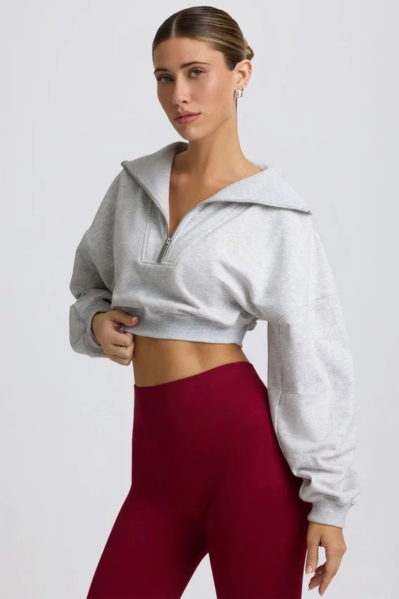 Kort sweatshirt med kvartslång dragkedja i gråmelerat Kort sweatshirt med kvartslång dragkedja i gråmelerat