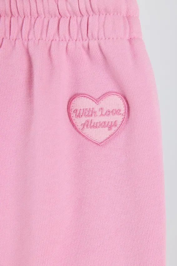 Mjuka joggingbyxor i bomullsjersey med medelhög midja och vida ben i babyrosa Mjuka joggingbyxor i bomullsjersey med medelhög midja och vida ben i babyrosa