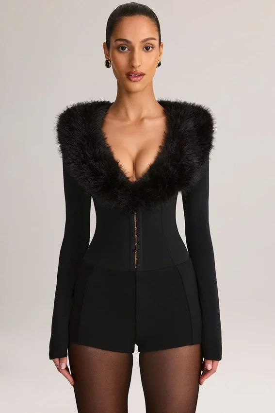 Nesta korsettplaysuit med fuskpälskant i svart Nesta korsettplaysuit med fuskpälskant i svart
