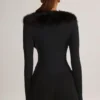 Nesta korsettplaysuit med fuskpälskant i svart Nesta korsettplaysuit med fuskpälskant i svart