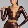 Rana crop top i metalliskt jersey med djup urringning i kopparbrons Rana crop top i metalliskt jersey med djup urringning i kopparbrons