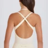 Stretchig bomullsjersey-bodys med korsrygg i krämfärg Stretchig bomullsjersey-bodys med korsrygg i krämfärg