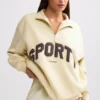 Sweatshirt med kvartslås i benvit Sweatshirt med kvartslås i benvit