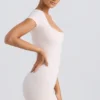 Unitard med rund halsringning i tvättad krämfärg Unitard med rund halsringning i tvättad krämfärg