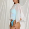 Zarayah genomskinlig poncho i vitt Zarayah genomskinlig poncho i vitt