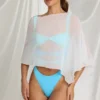 Zarayah genomskinlig poncho i vitt Zarayah genomskinlig poncho i vitt